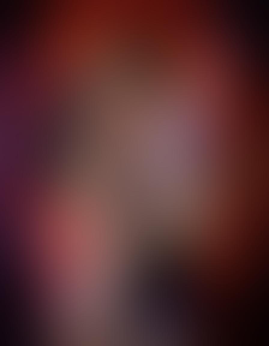 A captivating scene of two figures entwined in an intimate embrace, surrounded by intricate patterns symbolizing various kinks and sensuality. Soft lighting casts a warm glow, highlighting the tenderness and connection between them. Elements like feathers, silk ties, and delicate lace textures float around, suggesting a blend of exploration and depth in desires. The background is a dreamlike haze of rich purples and deep reds, evoking passion and mystery. super-realistic. vibrant colors. soft lighting.